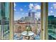 Balcony with a seating area offering stunning city skyline views at 860 Peachtree Ne St # 1008, Atlanta, GA 30308
