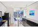 Open kitchen with stainless appliances and bar seating flowing into the modern living space at 860 Peachtree Ne St # 1008, Atlanta, GA 30308