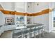 Amenity kitchenette with sleek countertops, bar seating, and storage cabinets in neutral tones at 860 Peachtree Ne St # 1008, Atlanta, GA 30308