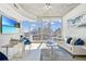 Bright living room featuring modern furnishings, balcony access, and stunning city views at 860 Peachtree Ne St # 1008, Atlanta, GA 30308