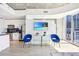 Open concept living room with kitchen, island, and balcony access at 860 Peachtree Ne St # 1008, Atlanta, GA 30308