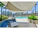 Community swimming pool and lounge area with shaded pergola and city views at 860 Peachtree Ne St # 1008, Atlanta, GA 30308