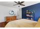 Bedroom with a queen bed, wood floors, blue accent wall and natural light at 1721 Clifton Se Way, Atlanta, GA 30316