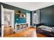 Bedroom featuring a dark teal paint, natural light, and hardwood floors at 1721 Clifton Se Way, Atlanta, GA 30316