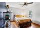 Cozy bedroom featuring a queen bed, hardwood floors, ceiling fan, and natural light at 1721 Clifton Se Way, Atlanta, GA 30316