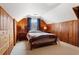 Charming bedroom featuring a sloped ceiling, wood paneling, and a cozy bed at 1721 Clifton Se Way, Atlanta, GA 30316