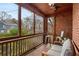 Relaxing enclosed porch with brick walls, tile floor, and cozy seating at 1721 Clifton Se Way, Atlanta, GA 30316