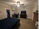 Bedroom featuring a ceiling fan, brick fireplace, and neutral walls at 3124 Usher Nw St, Covington, GA 30014