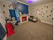 View of a bedroom featuring large carpet flooring, colorful walls, and a fireplace at 3124 Usher Nw St, Covington, GA 30014