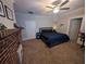 Bedroom with a decorative brick fireplace, ceiling fan, and neutral walls at 3124 Usher Nw St, Covington, GA 30014