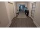 Hallway with light gray walls, wood-look flooring, and doors leading to other rooms in the house at 3124 Usher Nw St, Covington, GA 30014