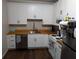 Well-lit kitchen featuring white cabinets, stainless steel appliances, and butcher block countertops at 3124 Usher Nw St, Covington, GA 30014