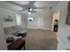 Spacious living room with plush carpeting, a comfortable sectional sofa, and a ceiling fan for added comfort at 3124 Usher Nw St, Covington, GA 30014