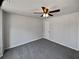 Bedroom featuring a ceiling fan, neutral walls, and plush gray carpet at 4906 Laythan Jace Ct, Snellville, GA 30039