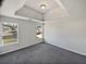 Spacious main bedroom featuring a tray ceiling and plush carpet at 4906 Laythan Jace Ct, Snellville, GA 30039