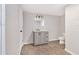 Bathroom featuring a vanity with gray cabinets, light fixtures and toilet at 185 Nickajack Se Rd, Mableton, GA 30126