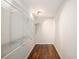 Walk-in closet featuring wire shelving, overhead lighting, neutral paint, and hardwood flooring at 185 Nickajack Se Rd, Mableton, GA 30126