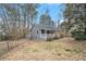 Exterior view of a cottage with gray siding, covered porch, and a chain-link fence at 185 Nickajack Se Rd, Mableton, GA 30126