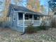 Charming home with a covered porch, gray siding, and landscaped yard at 185 Nickajack Se Rd, Mableton, GA 30126