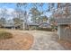 View of a gray house with brick chimney, siding and a circular driveway at 185 Nickajack Se Rd, Mableton, GA 30126