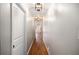 Hallway with hardwood flooring, neutral paint, and white trim leads to other rooms in the home at 185 Nickajack Se Rd, Mableton, GA 30126