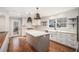 Wonderful kitchen is equipped with white cabinets, stainless appliances, farmhouse sink, and a gray kitchen island at 185 Nickajack Se Rd, Mableton, GA 30126