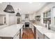 Lovely kitchen showcases a stainless steel range hood, white cabinets, and a large island with a stone counter at 185 Nickajack Se Rd, Mableton, GA 30126