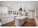 Modern kitchen featuring white cabinets, granite countertops, and stainless steel appliances at 185 Nickajack Se Rd, Mableton, GA 30126