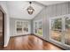 Inviting sunroom with vaulted ceilings, three large windows providing backyard views, and hardwood flooring at 185 Nickajack Se Rd, Mableton, GA 30126