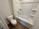 Bright bathroom with a white tub and toilet at 2371 Brown Dove Way Lot 4, Grayson, GA 30017