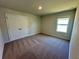 Bedroom featuring neutral carpet, a window, and a closet with double doors at 2371 Brown Dove Way Lot 4, Grayson, GA 30017