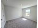 Bright bedroom featuring a window with blinds, neutral walls, and plush gray carpet at 2371 Brown Dove Way Lot 4, Grayson, GA 30017