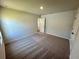 This carpeted bedroom offers neutral walls and a door to another room at 2371 Brown Dove Way Lot 4, Grayson, GA 30017