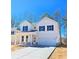Charming two-story white farmhouse featuring a two car garage and welcoming front porch at 2371 Brown Dove Way Lot 4, Grayson, GA 30017