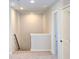 Upstairs hallway with neutral paint and carpet leads to additional rooms in the house at 2371 Brown Dove Way Lot 4, Grayson, GA 30017