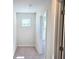 Hallway has carpet floors, baseboards and light gray paint with door leading to more rooms at 2371 Brown Dove Way Lot 4, Grayson, GA 30017
