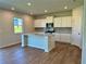 Well-lit kitchen with modern appliances and a center island, creating a functional and inviting space at 2371 Brown Dove Way Lot 4, Grayson, GA 30017
