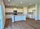 Spacious kitchen featuring white cabinetry, stainless steel appliances, and a center island with a sink at 2371 Brown Dove Way Lot 4, Grayson, GA 30017