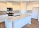 Bright kitchen with white cabinets, island, and stainless steel appliances at 2371 Brown Dove Way Lot 4, Grayson, GA 30017