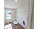 Bright laundry room with hardwood floors, shelving, and natural light at 2371 Brown Dove Way Lot 4, Grayson, GA 30017