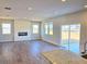 Open living room featuring wood floors, fireplace, and sliding glass door leading to the backyard at 2371 Brown Dove Way Lot 4, Grayson, GA 30017