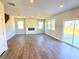 Bright living room with wood floors, fireplace, and natural light from multiple windows at 2371 Brown Dove Way Lot 4, Grayson, GA 30017
