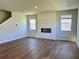 Modern living room featuring wood floors, a sleek fireplace, and sun-filled windows at 2371 Brown Dove Way Lot 4, Grayson, GA 30017