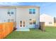 A well-maintained backyard with a patio, grassy lawn, and fenced perimeter at 579 Magnolia Cir, Palmetto, GA 30268