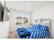 Cozy bedroom with a TV, blue bedding and a window offering a neighborhood view at 579 Magnolia Cir, Palmetto, GA 30268