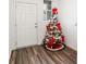 Welcoming entryway features luxury vinyl plank flooring and a festive Christmas tree at 579 Magnolia Cir, Palmetto, GA 30268
