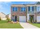 Charming brick townhome featuring a well-manicured lawn and attached one car garage at 579 Magnolia Cir, Palmetto, GA 30268
