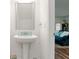 Bright powder room with a pedestal sink and a decorative mirror at 579 Magnolia Cir, Palmetto, GA 30268