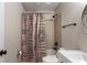 Charming bathroom with tiled shower and tub, modern sink vanity, and unique round mirror at 806 Marcus Se St # 21, Atlanta, GA 30316