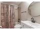Charming bathroom with tiled shower and tub, modern sink vanity, and unique round mirror at 806 Marcus Se St # 21, Atlanta, GA 30316